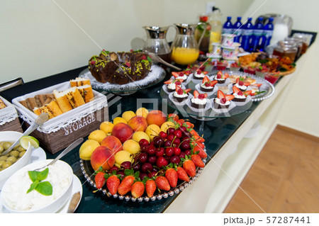 Healthy fruit platter, strawberries cherries oranges peaches apples apricots on the table, close up 57287441