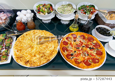 Food and Buffet Decoration with pizza and lots of dishes in a hotel Food and Buffet Decoration with pizza and lots of dishes in a hotel 57287443