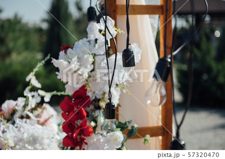 Decoration wedding arch with white and pink flowers on a green natural background. 57320470