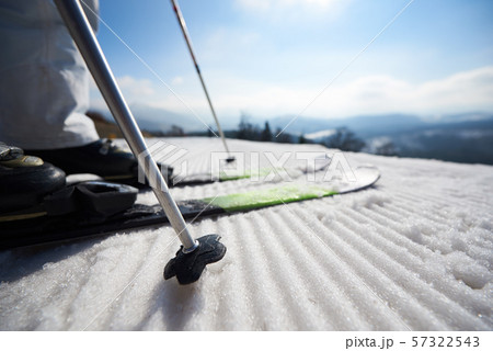 Skier legs in white snow, beautiful winter mountain landscape and blue sky copy space background. 57322543