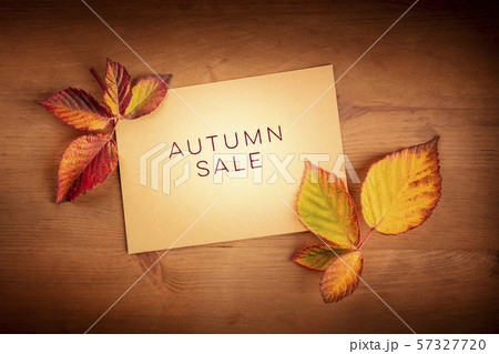 Autum Sale. Discount banner or flyer design template with vibrant autumn leaves on a brown kraft Autum Sale. Discount banner or flyer design template with vibrant autumn leaves on a brown kraft 57327720