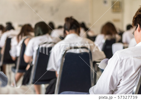 Blur school background university students writing answer doing exam in classroo 57327739