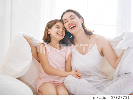 girl and her mother enjoying sunny morning 57327751