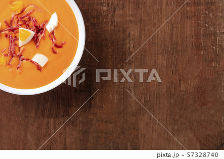 Salmorejo, Spanish cold tomato soup, close-up shot from the top on a dark rustic wooden background 57328740