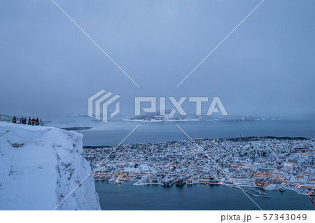 People admiring the view of the city of Tromso 57343049