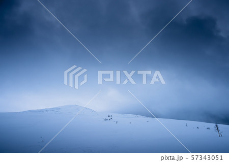 Snow covered Storsteinen mountain summit 57343051