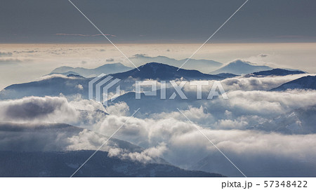 Fog over mountain at sunrise in Piedmont, Italy 57348422