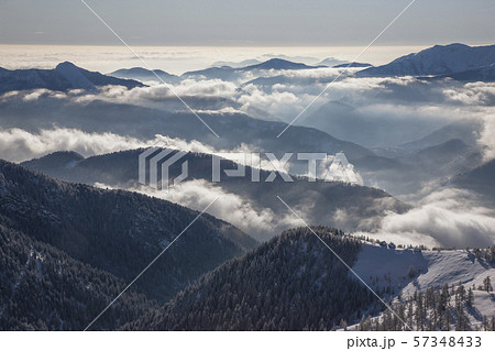 Fog over forest covered mountains in Piedmont, Italy 57348433