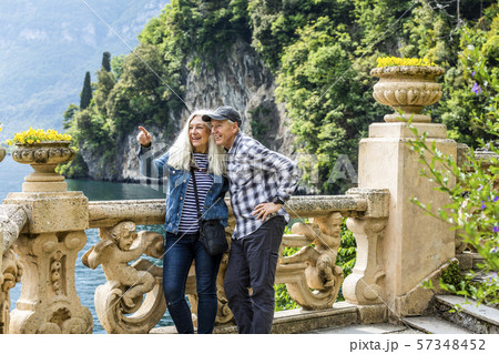Smiling couple at Villa del Balbianello by Lake Como, Italy Smiling couple at Villa del Balbianello by Lake Como, Italy 57348452