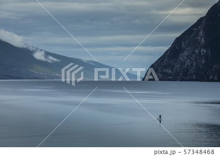 Man paddleboarding on Lake Garda, Italy 57348468