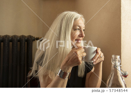 Woman holding coffee cup in cafe Woman holding coffee cup in cafe 57348544