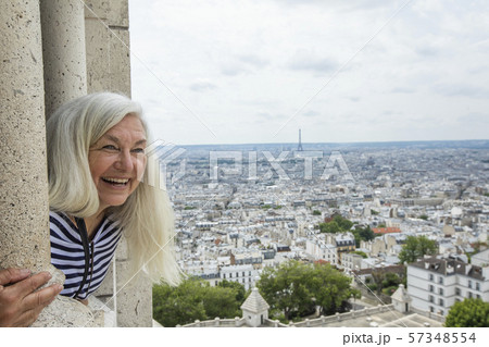 Smiling woman by cityscape from Sacre Coeur in Paris, France Smiling woman by cityscape from Sacre Coeur in Paris, France 57348554
