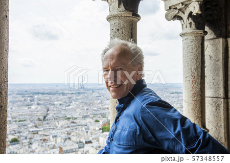 Smiling man by cityscape from Sacre Coeur in Paris, France 57348557