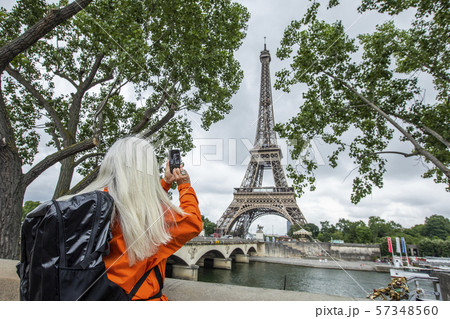 Woman photographing Eiffel Tower with smart phone in Paris, France 57348560