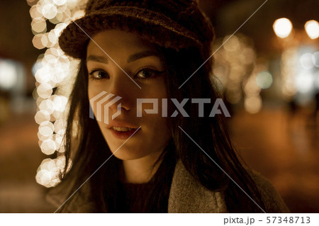 Portrait of young woman wearing woolly hat at night Portrait of young woman wearing woolly hat at night 57348713