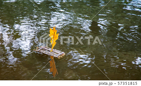 toy raft with a sail floating on the lake 57351815