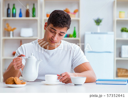 Man falling asleep during his breakfast after overtime work Man falling asleep during his breakfast after overtime work 57352641