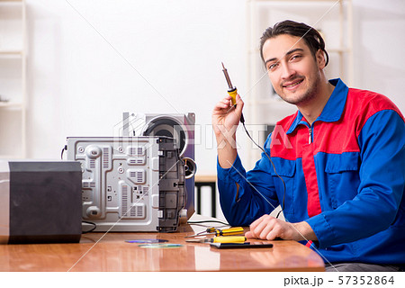 Young engineer repairing musical hi-fi system Young engineer repairing musical hi-fi system 57352864