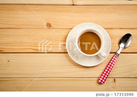 Small cup with aromatic coffee with milk on wooden table 57353090