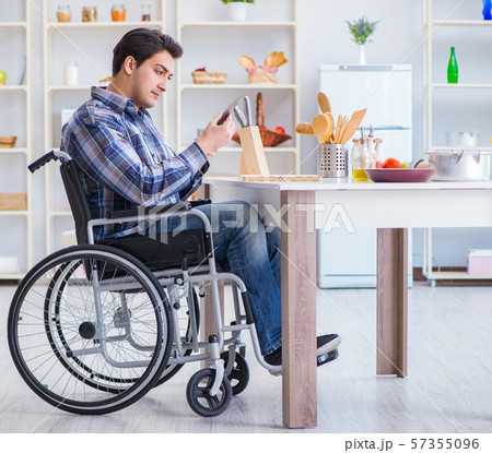 Disabled young man husband working in kitchen Disabled young man husband working in kitchen 57355096