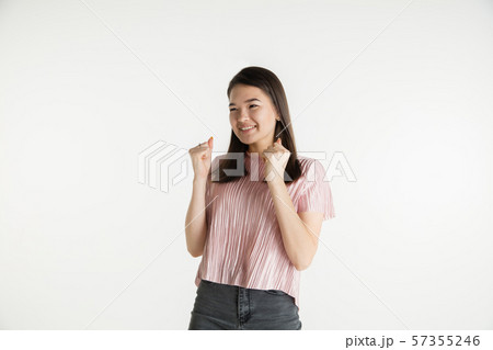 Beautiful girl's half-length portrait on white studio background Beautiful girl's half-length portrait on white studio background 57355246