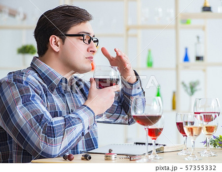 Professional sommelier tasting red wine 57355332