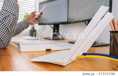 closeup of a wireless router and a man using 57355790