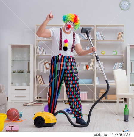 Funny clown doing cleaning at home 57356728