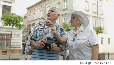 Senior two male and female tourists in city center. Traveling in Lviv, Ukraine. 57357371