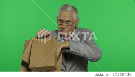 Elderly businessman with shopping bags. Old man in formal wear after shopping Elderly businessman with shopping bags. Old man in formal wear after shopping 57359439