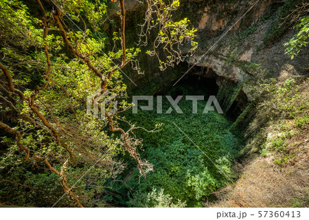 Deep natural sink hole in Grisel, Aragon, Spain. Deep natural sink hole in Grisel, Aragon, Spain. 57360413