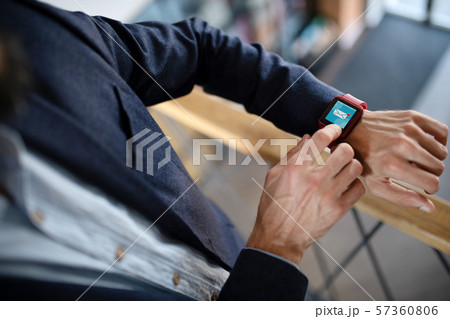 Businessman using smart watch receiving e-mail from secretary Businessman using smart watch receiving e-mail from secretary 57360806