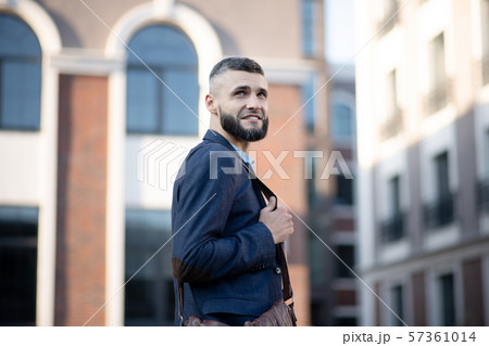 Man having good mood while walking to office in the morning Man having good mood while walking to office in the morning 57361014