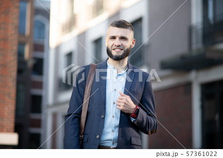 Young man wearing smart watch walking to the office Young man wearing smart watch walking to the office 57361022