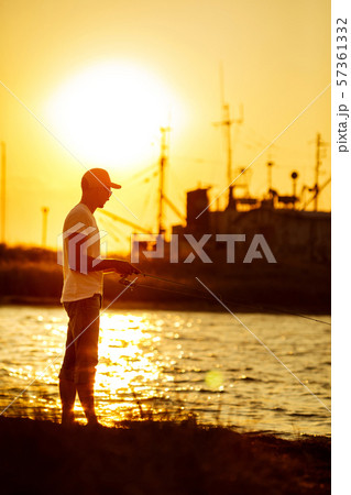 Young man fishing at sea Young man fishing at sea 57361332