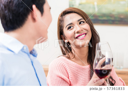 Happy couple toasting red wine glasses 57361833