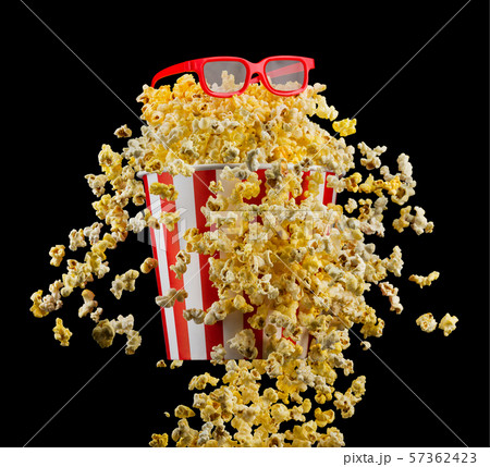 Flying popcorn from striped bucket isolated on black background Flying popcorn from striped bucket isolated on black background 57362423