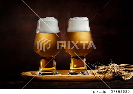 two glasses of cold golden beer and wheat spikelets 57362680
