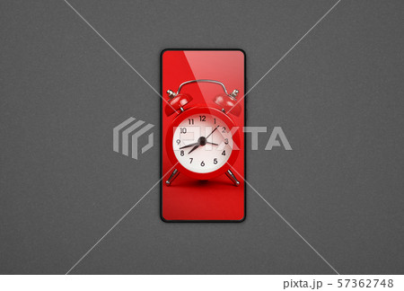 Smartphone with red alarm clock screen over grey Smartphone with red alarm clock screen over grey 57362748