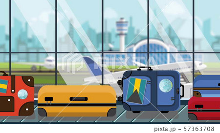Suitcases with Bahamian flag stickers on baggage carousel in airport, close-up. Tourism in Bahamas 57363708