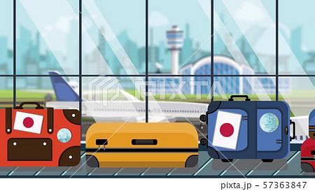 Baggage with Japanese flag stickers on carousel in airport, close-up. Travel to Japan related Baggage with Japanese flag stickers on carousel in airport, close-up. Travel to Japan related 57363847