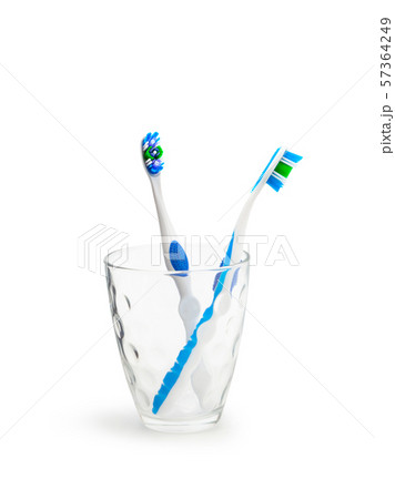 Toothbrushes in glass isolated on white Toothbrushes in glass isolated on white 57364249