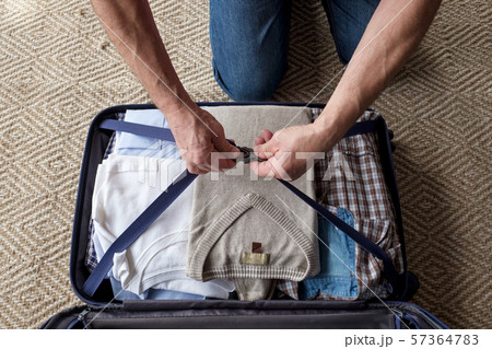 Senior man hands packing clothes in suitcase. Senior man hands packing clothes in suitcase. 57364783