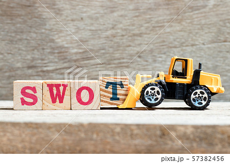 Toy bulldozer hold letter block T to complete word SWOT Toy bulldozer hold letter block T to complete word SWOT 57382456