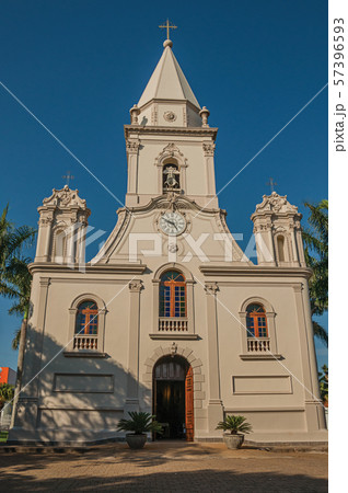 Church facade and belfry in front of a small garden at Sao Manuel 57396593