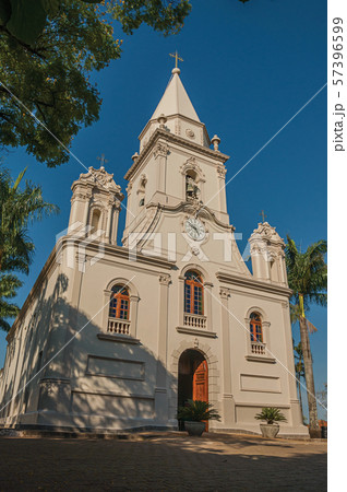 Church facade and belfry in front of a small garden at Sao Manuel Church facade and belfry in front of a small garden at Sao Manuel 57396599