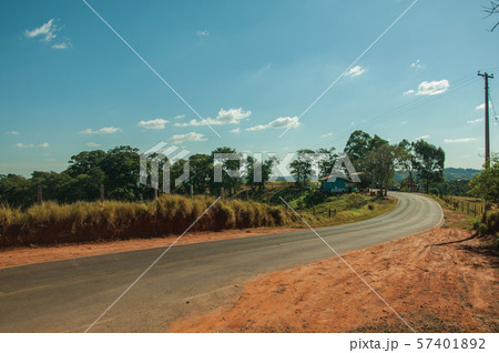 Countryside road on landscape covered by meadows 57401892