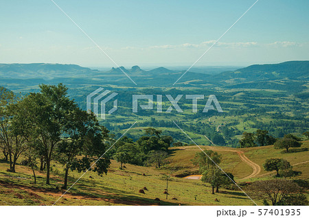 Meadows and trees in a green valley with hilly landscape 57401935