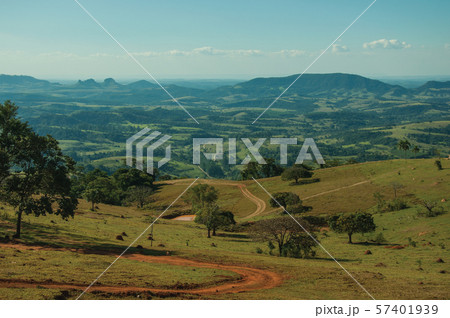 Meadows and trees in a green valley with hilly landscape 57401939