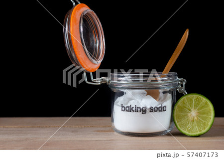 Baking soda with lemon on wooden on black 57407173